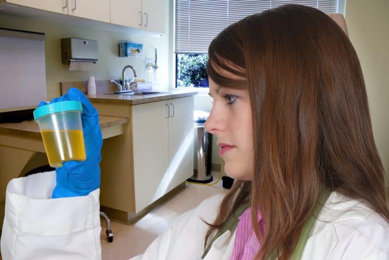 a doctor looking at a urine sample