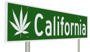 a green highway sign for California with a marijuana leaf