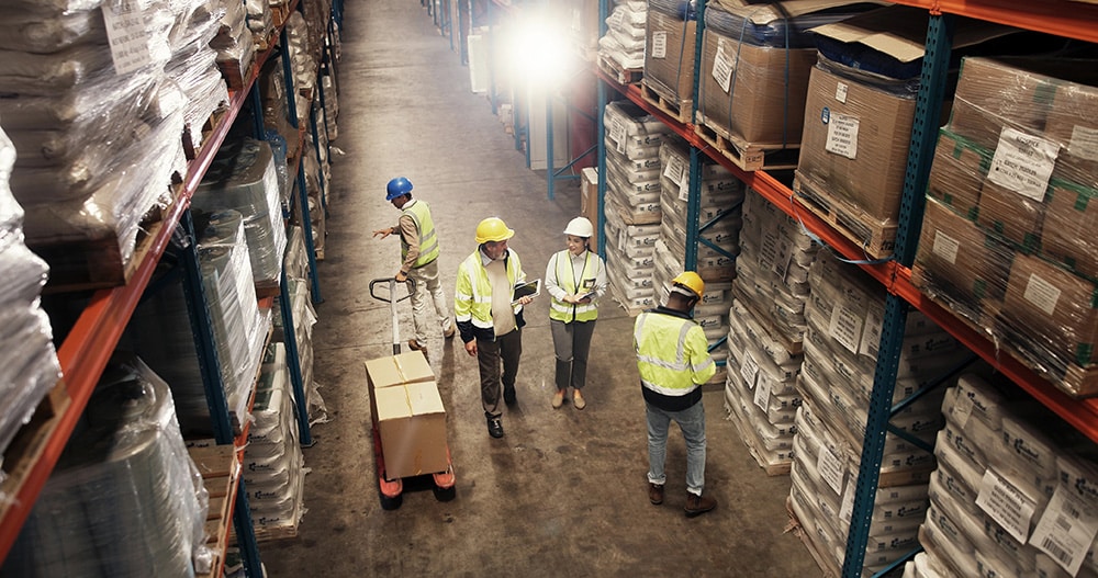 Warehouse workers taking inventory and using a pallet jack