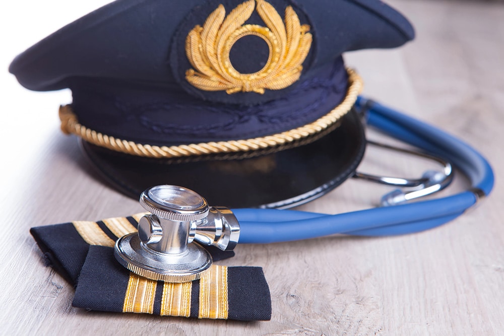 Pilot's cap and epaulettes on top of a stethoscope - FAA Drug Testing
