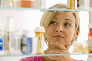 Woman looking into a medicine cabinet