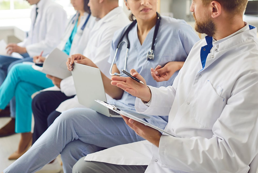 doctors sitting and working together - training and consulting